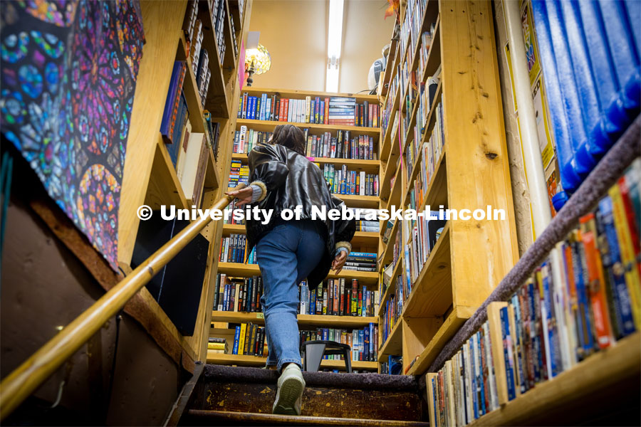 Ariana Joy Cobler walks up the stairs at A Novel Idea Bookstore. About Lincoln at A Novel Idea Bookstore. October 18, 2023. Photo by Kristen Labadie / University Communication.